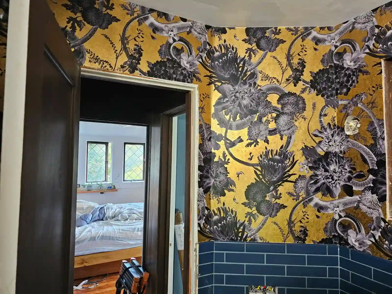 Professional wallpaper installer at work in Michigan home